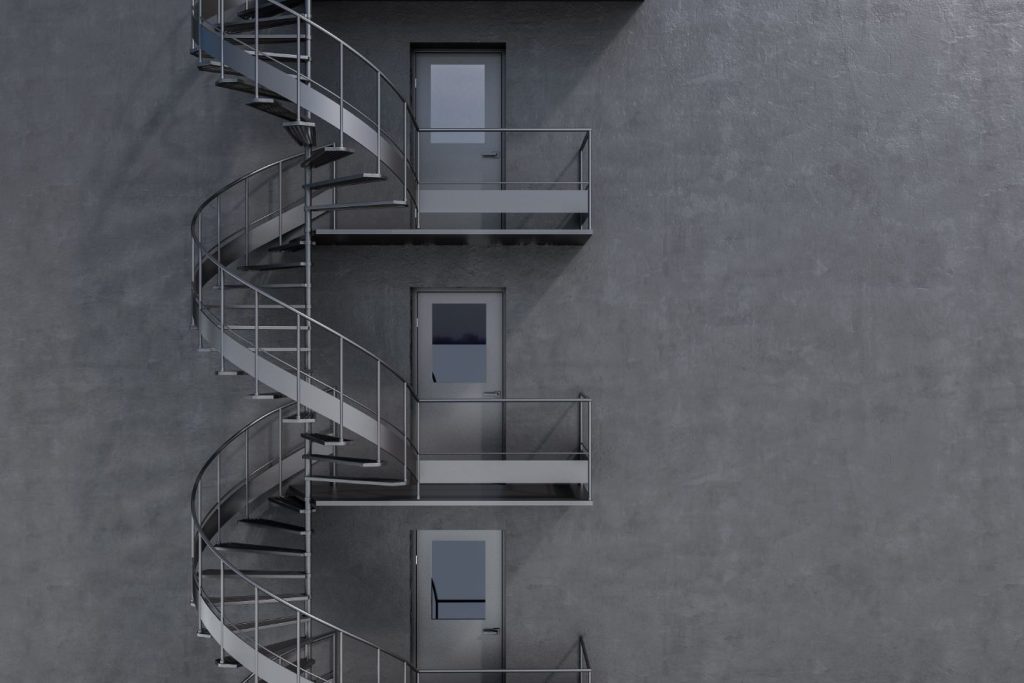 Grey building with spiral fire escape stairs